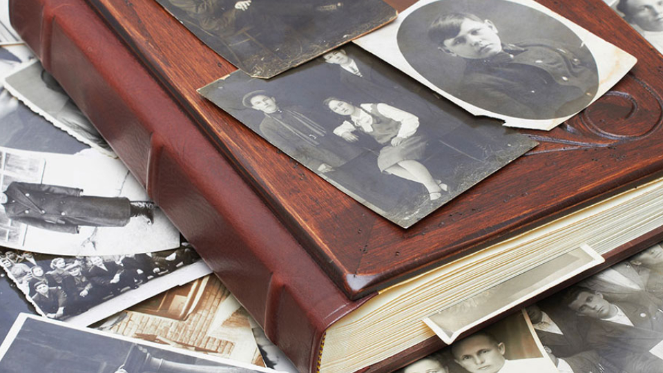 Closeup of a pile of vintage family photos.